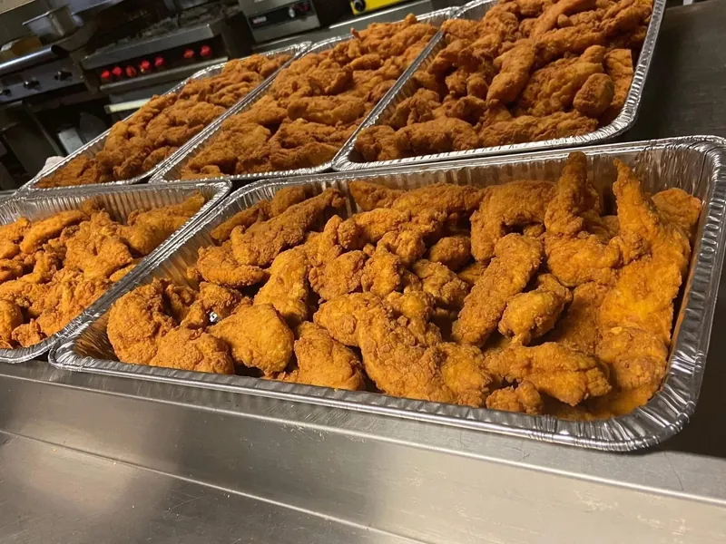 Trays of Fireside's famous fried chicken tenders prepared for catering