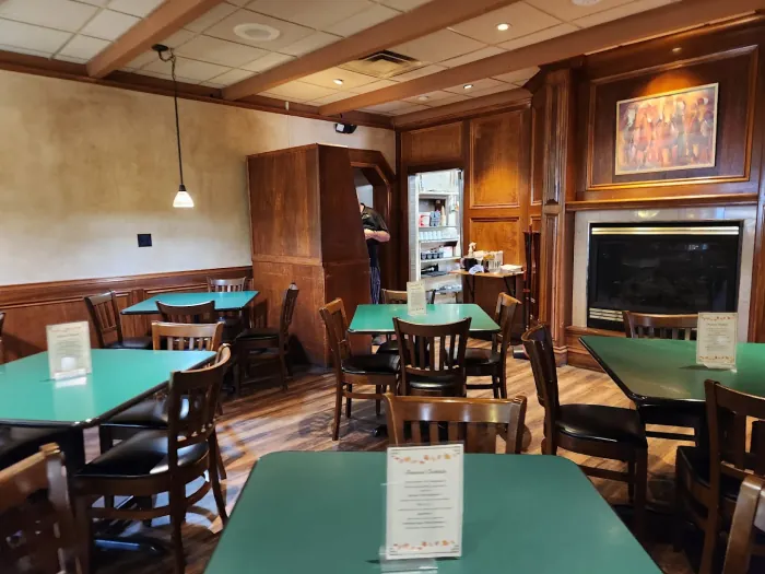 Dining room at The Fireside Bar and Grill with a stone fireplace
